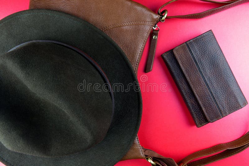 Felt Hat with Leather Bag and Leather Wallet on a Red Surface Stock