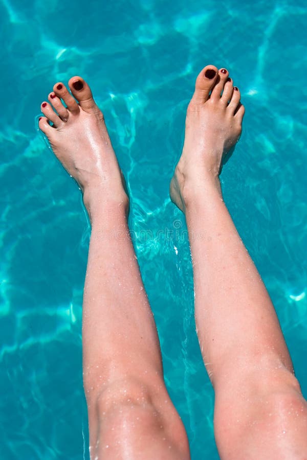 Femails foots in water royalty free stock photo