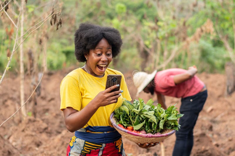 female african farmer checking her phone