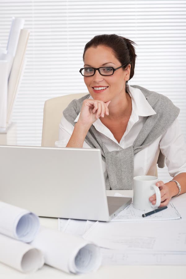 Female architect with laptop and coffee sitting stock photos