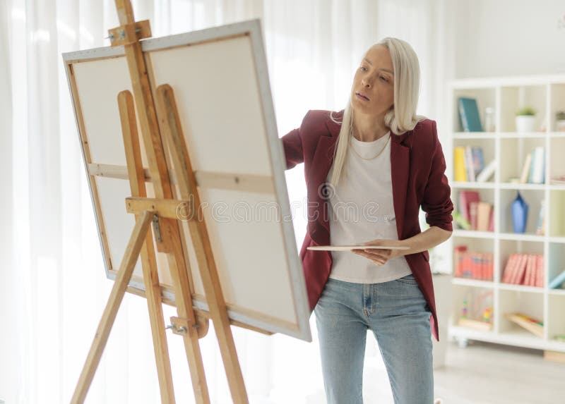 Female artist painting on an easel stock photos