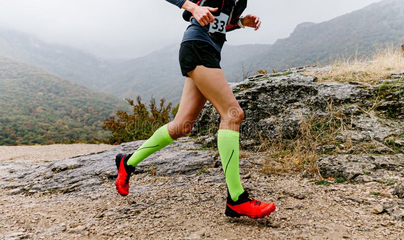 Female Athlete in Compression Socks Running Mountain Trail Race Stock ...
