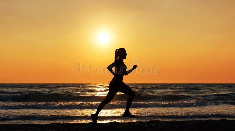 Female athlete running on the beach at sunset royalty free stock photo Female athlete running on the beach at sunset royalty free stock photo