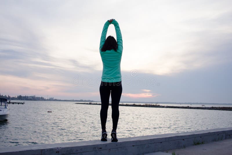 Exercises with sunrise. Beautiful disabled athlete woman in