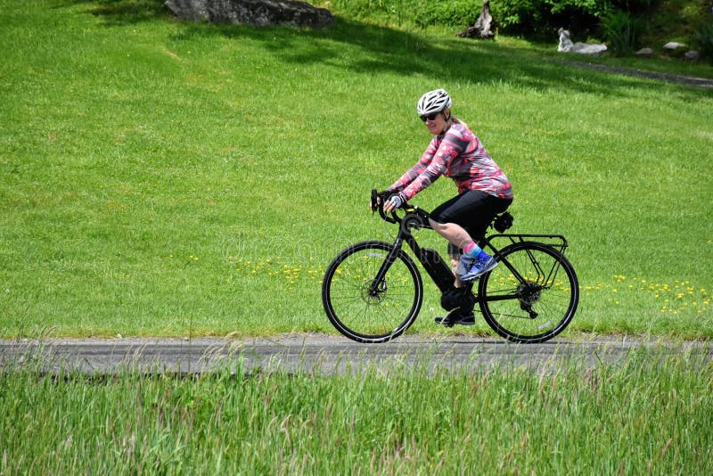 Female baby boomer enjoying e-bike ride