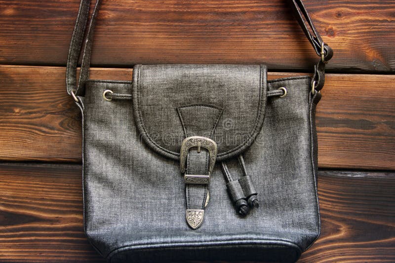 Female bag on a wooden background. Close up royalty free stock image Female bag on a wooden background. Close up royalty free stock image