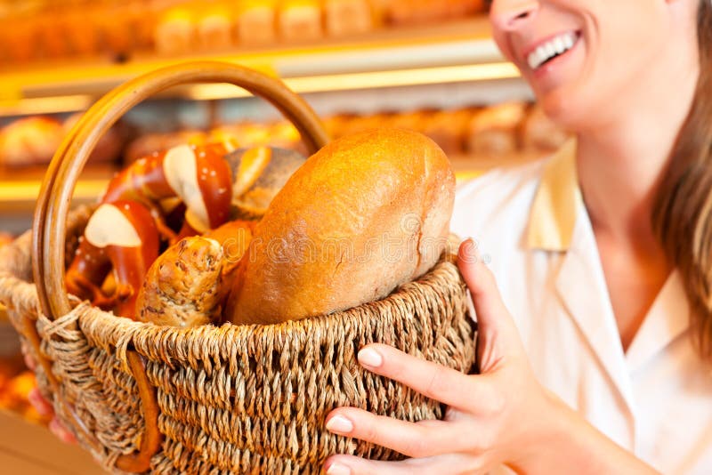 Download Female Baker Selling Bread By Basket In Bakery Stock Photo - Image of shop, retail: 32378716