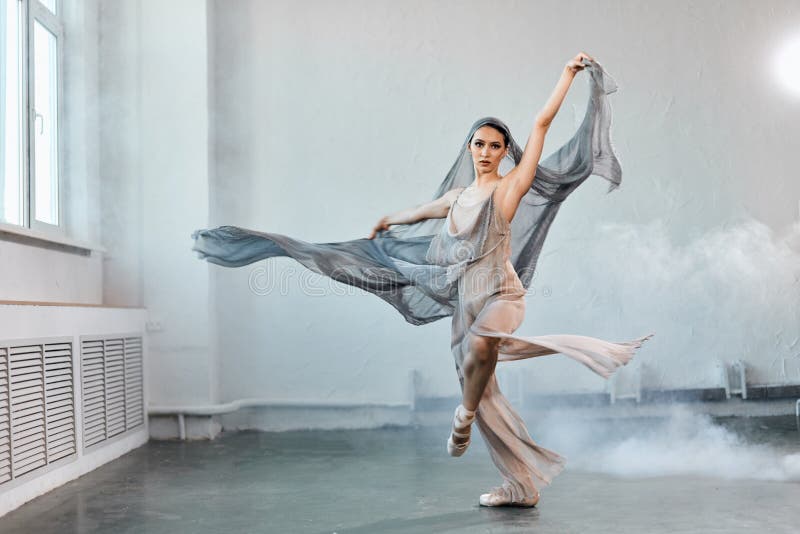 Female ballet dancer with white flowing fabric. Flow shapes and movement.