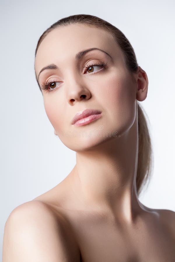 Female Beauty Vertical Portrait Shot With Nude Makeup On A White