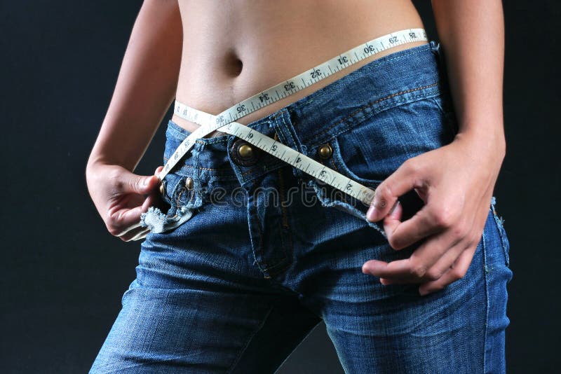 Female belly with tape measure stock photos