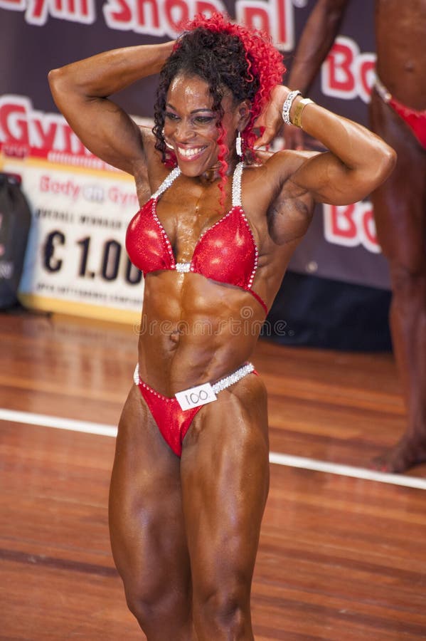 MAASTRICHT, THE NETHERLANDS - OCTOBER 25, 2015: Female Fitness Bikini Model  Evelyn Dirocie Shows Her Best Front Pose At Championship On Stageat The  World Grandprix Bodybuilding And Fitness Of The WBBF-WFF On