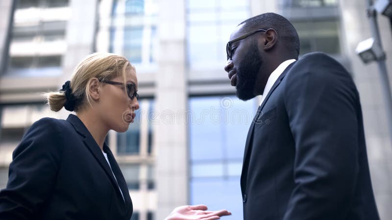 Female boss scolding subordinate, employee justifying himself, business ethics stock photography Female boss scolding subordinate, employee justifying himself, business ethics stock photography
