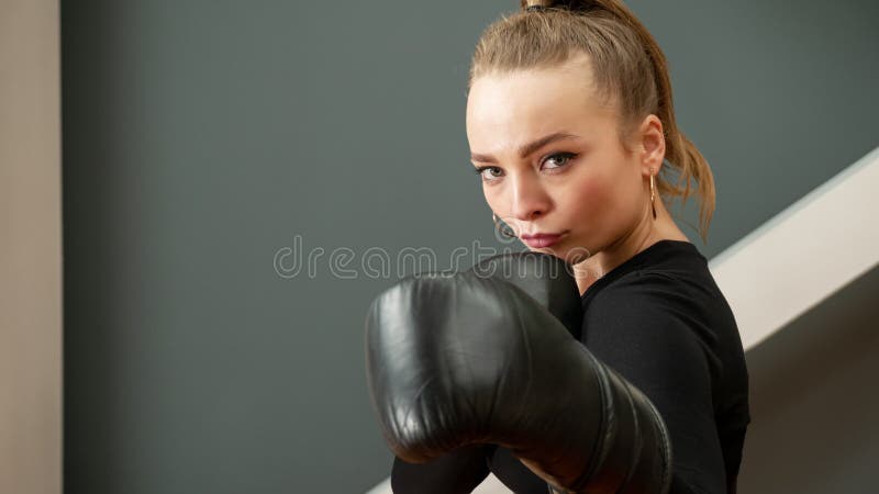 Female boxer in black gloves