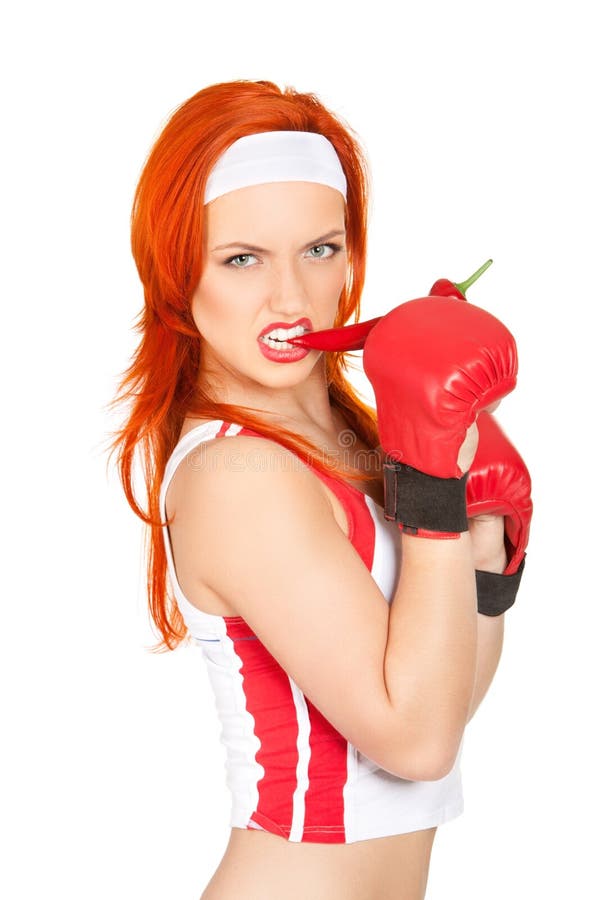 Portrait of pretty and angry female boxer biting hot chili pepper. Portrait of pretty and angry female boxer biting hot chili pepper
