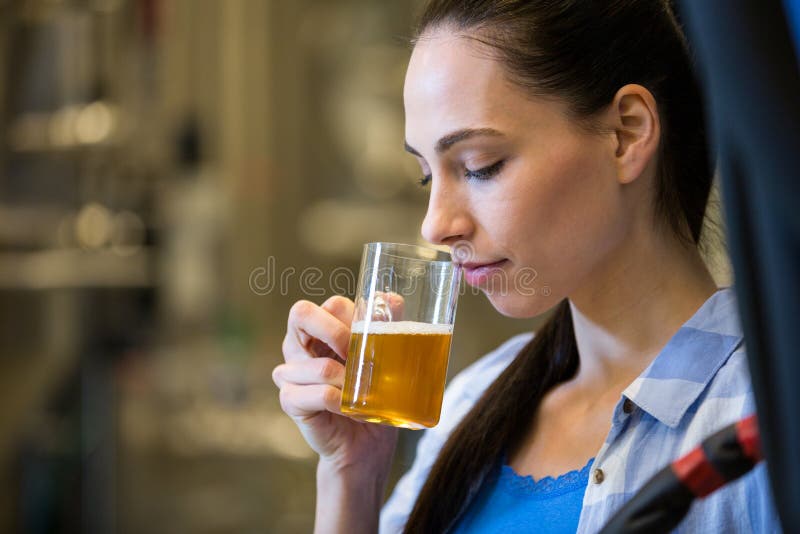 Female brewer testing beer stock image. Image of holding 77695045