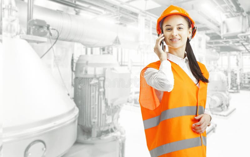 Destroying gender stereotypes. Female builder standing against industrial background royalty free stock photos Destroying gender stereotypes. Female builder standing against industrial background royalty free stock photos