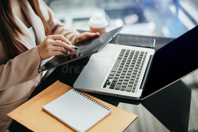 Female businessman and financial concepts about office work. Analysts discuss business with tablet and laptop as a tool.