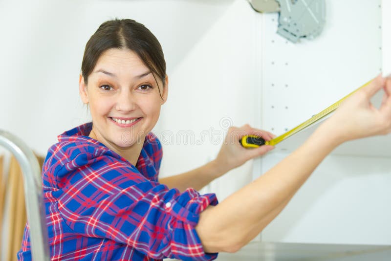 Female Carpenter Measuring Cupboard Stock Photo Image of repair
