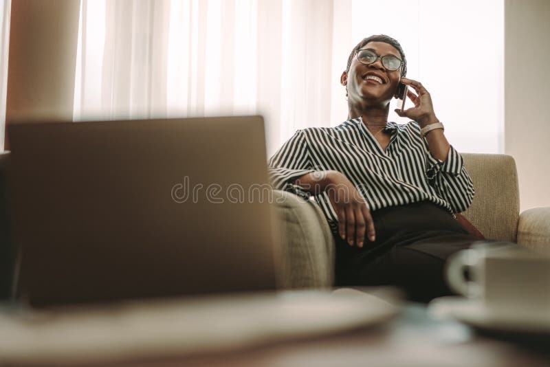 Female CEO in hotel room making phone call