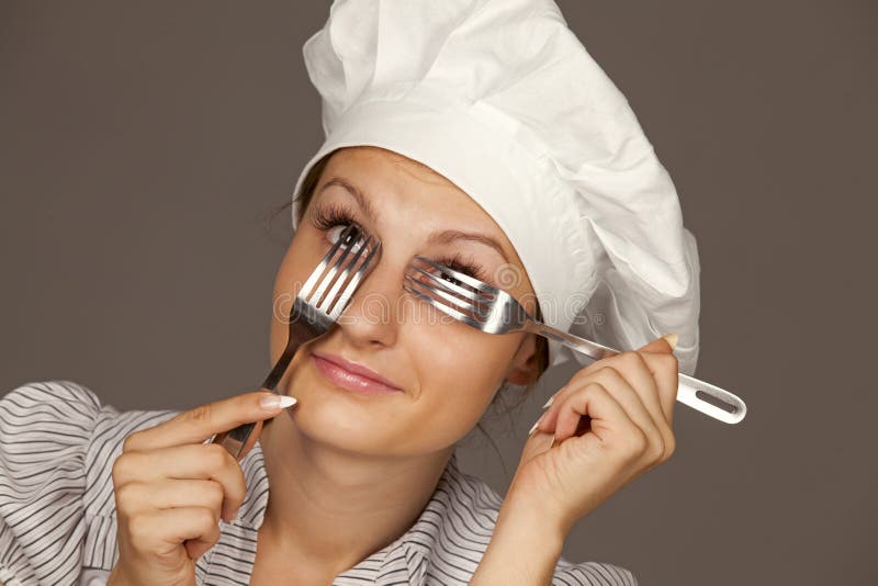 Female Chef looking through forks