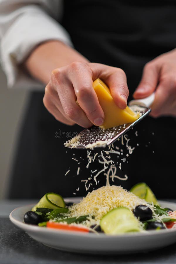 https://thumbs.dreamstime.com/b/female-chef-white-uniform-black-apron-restaurant-kitchen-cooking-salad-cook-rubs-parmesan-cheese-vegetables-183777238.jpg