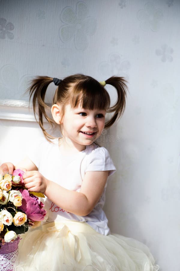 Photo of Female child sitting on the chest of drawers