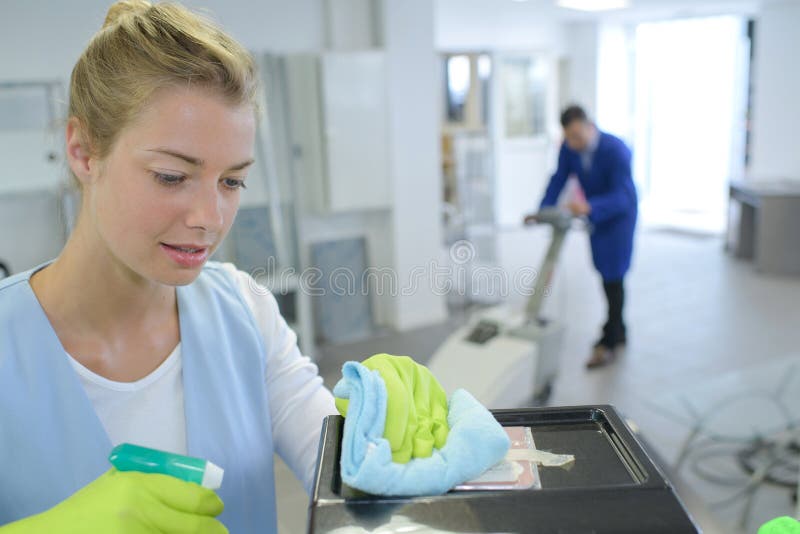 Female cleaner cleaning corridor business building stock photos Female cleaner cleaning corridor business building stock photos