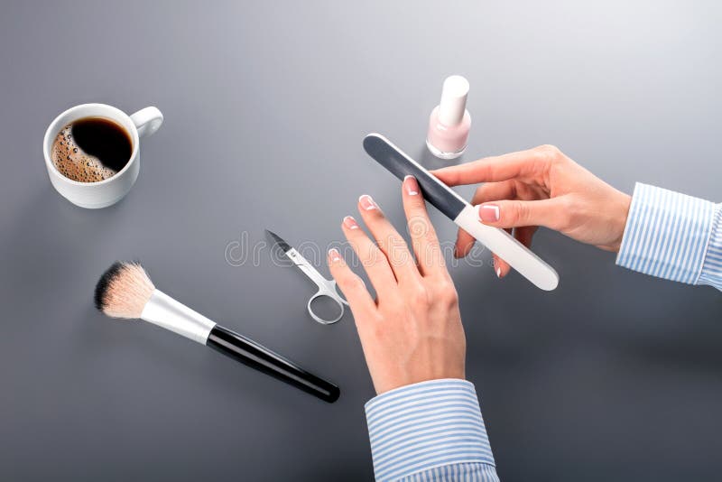 Female clerk using nail file.