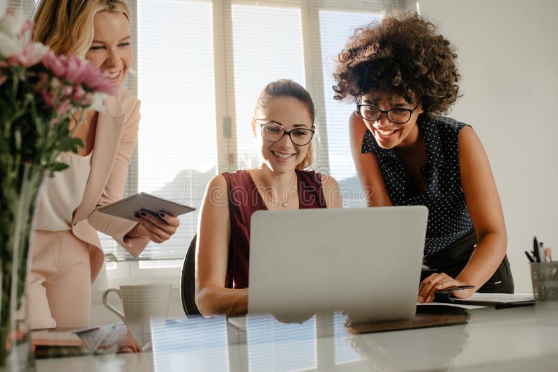 Female colleagues enjoying working together