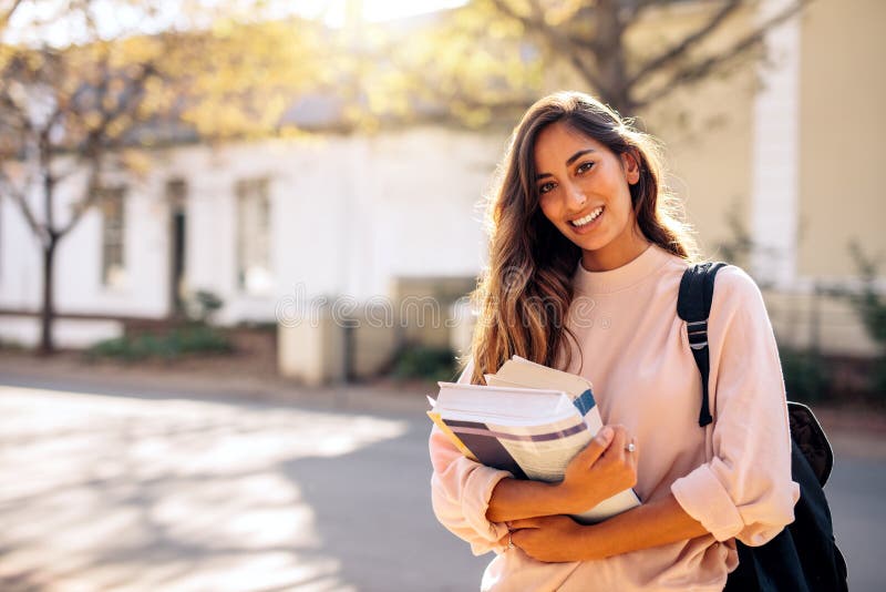Female college student with books outdoors royalty free stock image Female college student with books outdoors royalty free stock image