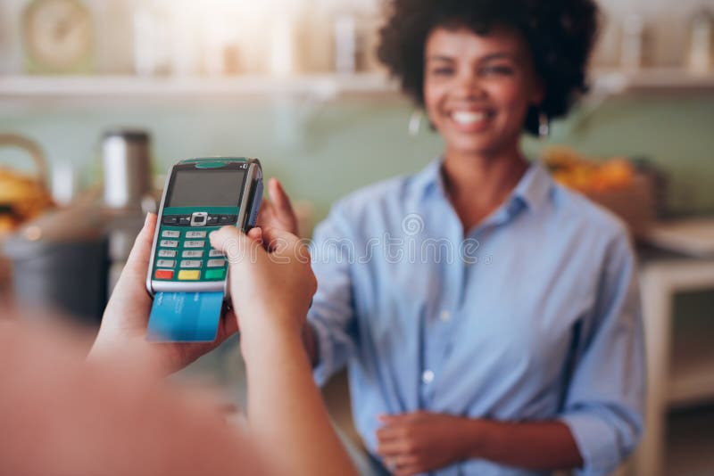 Female customer paying by credit card at juice bar