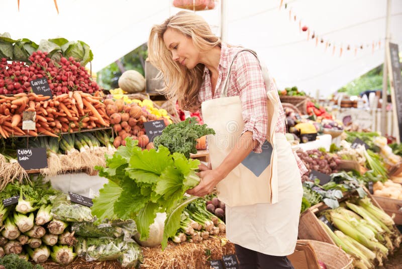 Female Customer Shopping At Farmers Market Stall royalty free stock images Female Customer Shopping At Farmers Market Stall royalty free stock images