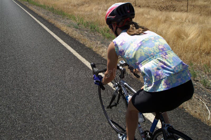 Female Cyclist on Country Road