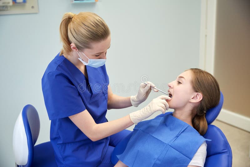 Female dentist checking patient girl teeth royalty free stock images Female dentist checking patient girl teeth royalty free stock images