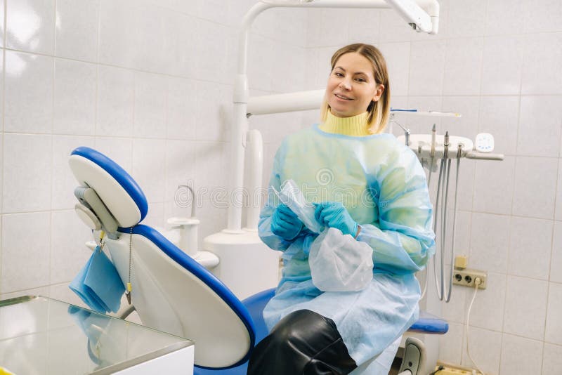 A Female Dentist Sits in Her Dental Office after Work Stock Image