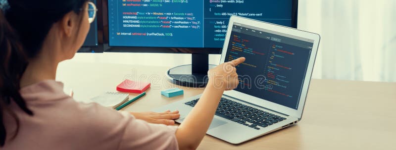 Female Developer Coding on Laptop while Computer Display Program ...