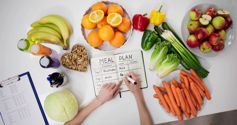 Female Dietitian Doctor Writing Meal Plan stock photos