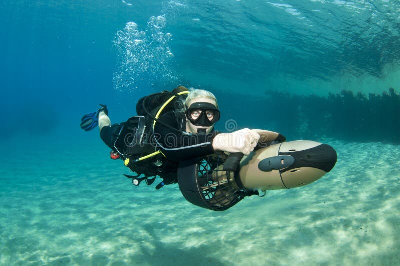 Female diver on underwater scooter