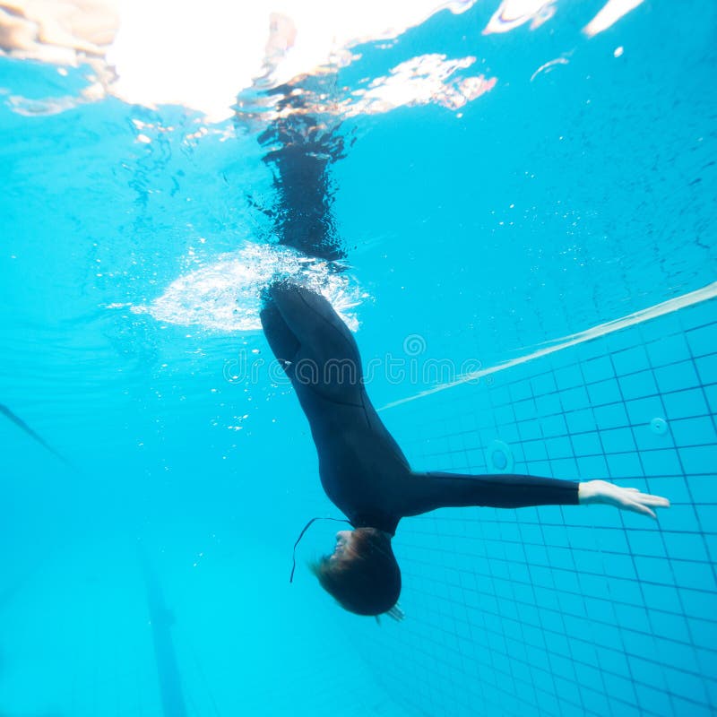 Female diving downwards in swimming pool royalty free stock image Female diving downwards in swimming pool royalty free stock image
