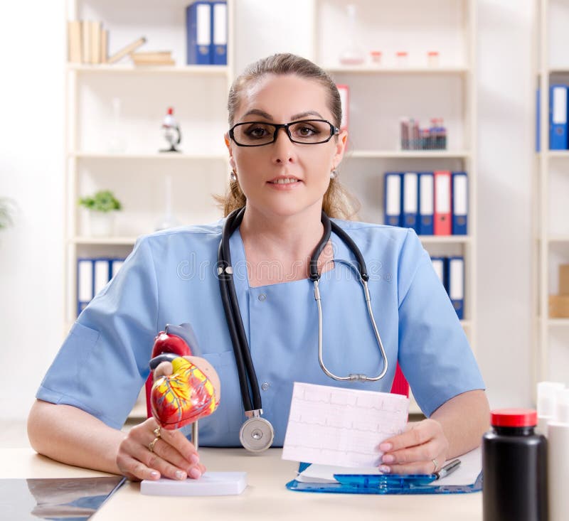 The Female Doctor Cardiologist Working in the Clinic Stock Image