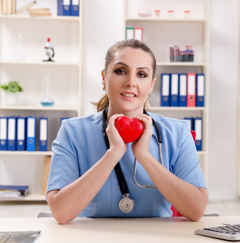 The Female Doctor Cardiologist Working in the Clinic Stock Image