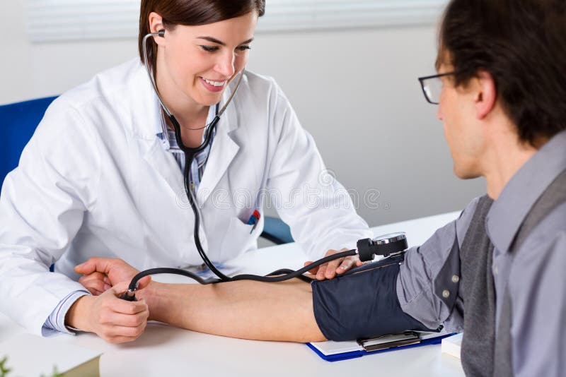 Female Doctor Checking Blood Pressure Of Patient stock photo Female Doctor Checking Blood Pressure Of Patient stock photo