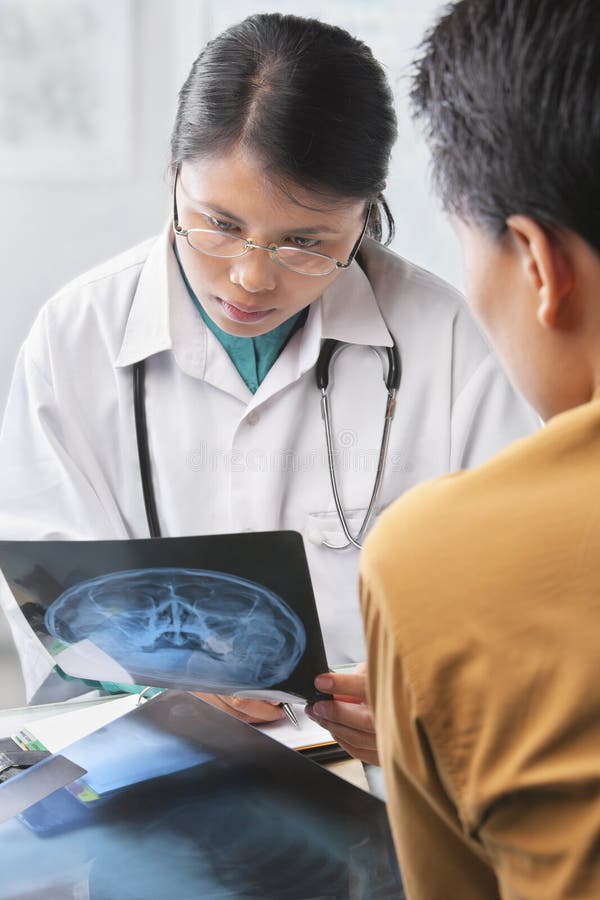 Female doctor checking patient xray