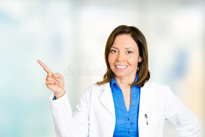 Female doctor cheerful healthcare professional pointing away stock photo Female doctor cheerful healthcare professional pointing away stock photo
