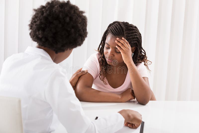 Female Doctor Comforting Depressed Patient stock image Female Doctor Comforting Depressed Patient stock image