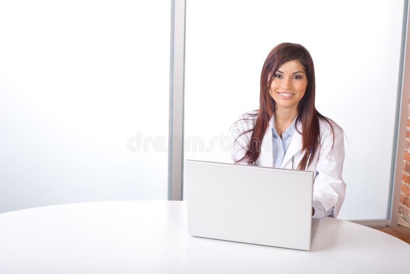 Female doctor on computer at desk