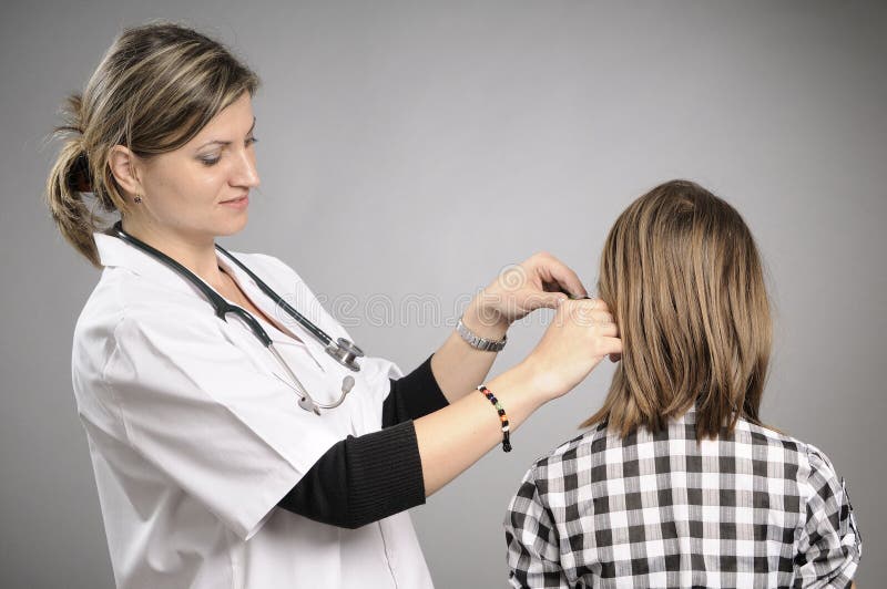 Female doctor examining ear