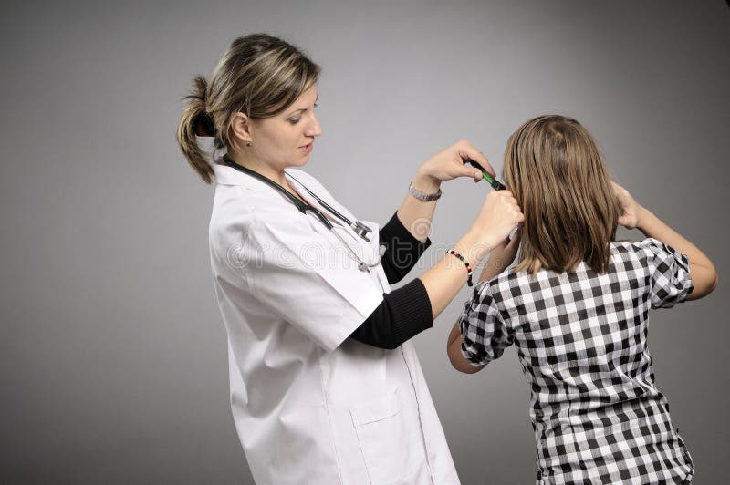 Female doctor examining ear