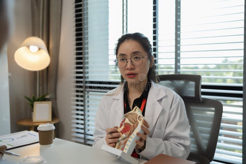 A female doctor is explaining the systems in the human body to two interns, three doctors are meeting to discuss the most royalty free stock images