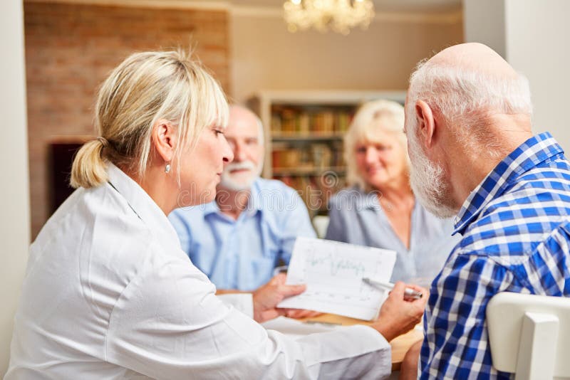 Female doctor looks after seniors in a therapy session royalty free stock photos Female doctor looks after seniors in a therapy session royalty free stock photos
